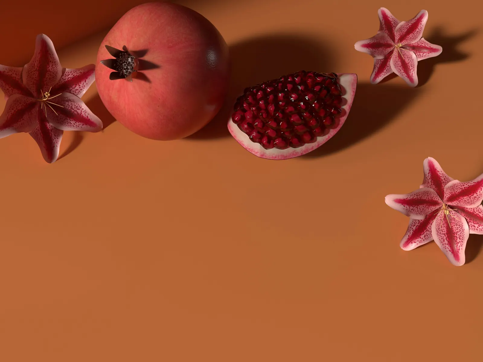 An opened pomegranate full of seeds on a warm orange surface