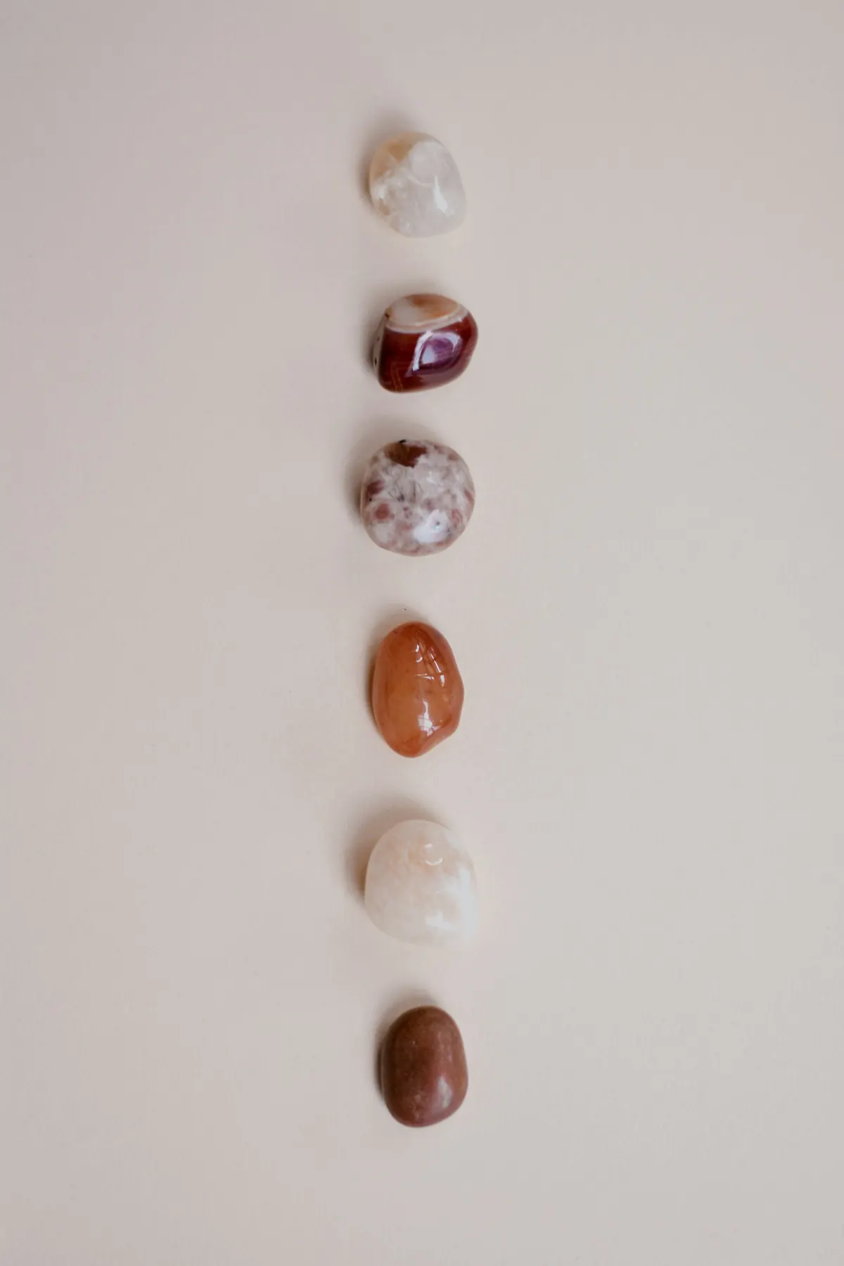 Six polished stones arranged in a vertical line